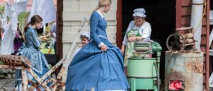 Girls in Victorian Costume with Washer Woman and old wringer machine